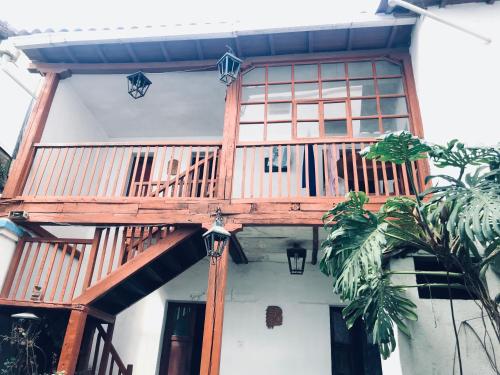 a wooden deck on the side of a house at Hostal Chasqui in Otavalo