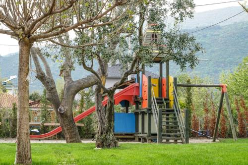 a playground with a slide in a park at Aloria Garden Hotel in Erdek