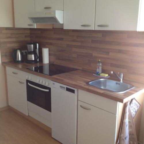 a kitchen with a sink and a counter top at Ferienwohnung am Schlossparkcenter in Schwerin