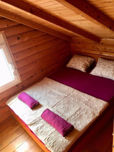 a room with two bunk beds in a log cabin at Summer Holiday House MM in Ulcinj