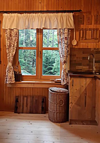 a kitchen with a window and a sink and a basket at DOM NAD POTOKIEM in Zawoja