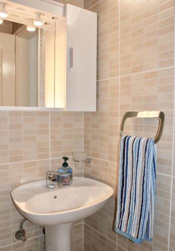a bathroom with a sink and a mirror at Studio apartments Morinj in Donji Morinj