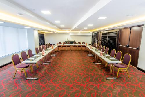 a conference room with long tables and chairs in it at Sonesta Hotel Cali in Cali