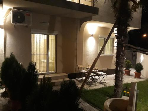 a house with a table and chairs in a yard at Vila & Apartments MATEA in Gevgelija