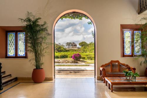 an archway in a room with a couch and a table at Mayaland Hotel & Bungalows in Chichén-Itzá