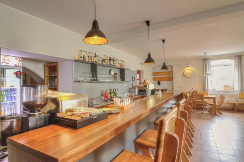 a bar in a restaurant with a counter and chairs at Pension Žacléřský Medvěd in Žacléř