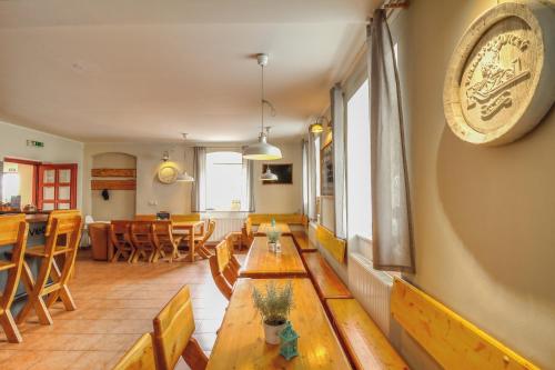 a dining room with wooden tables and chairs at Pension Žacléřský Medvěd in Žacléř