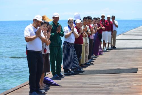 a group of people standing on a pier at Paradee in Ko Samed