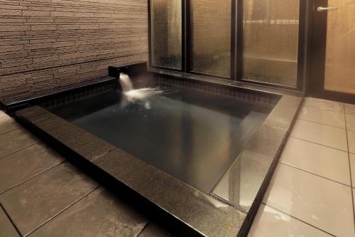 a pool in the floor of a building at karaksa hotel Sapporo in Sapporo