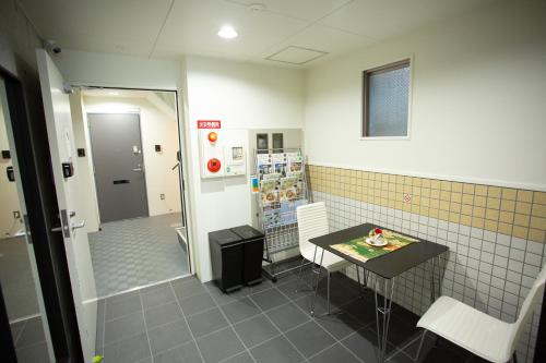 a room with a small table and a small room with at Rest inn Kyoto in Kyoto