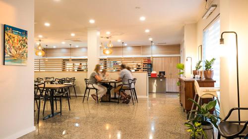 two people sitting at a table in a restaurant at Geraldton Motor Inn in Geraldton