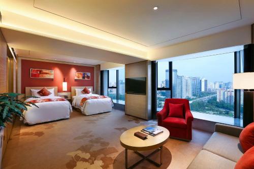 a hotel room with two beds and a large window at Grand Metropark Hotel Beijing in Beijing