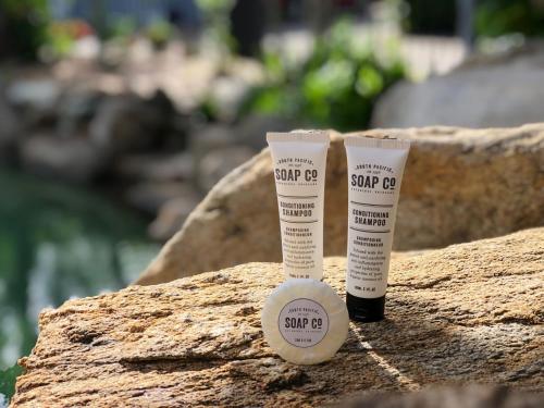 two bottles of sunscreen sitting on top of a rock at Motel Nomad in Cairns