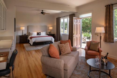 a living room with a bed and a couch at Wine Country Inn Napa Valley in St. Helena