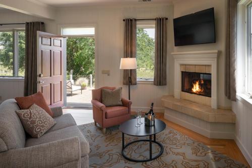 a living room with a couch and a fireplace at Wine Country Inn Napa Valley in St. Helena