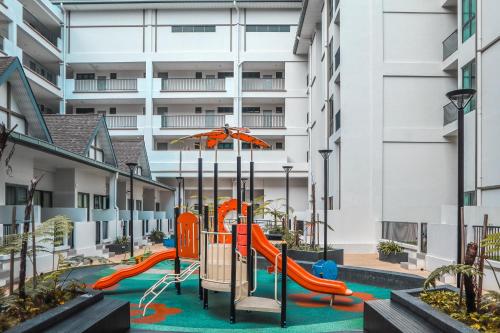a playground in the courtyard of a apartment building at Avillion Cameron Highlands in Cameron Highlands