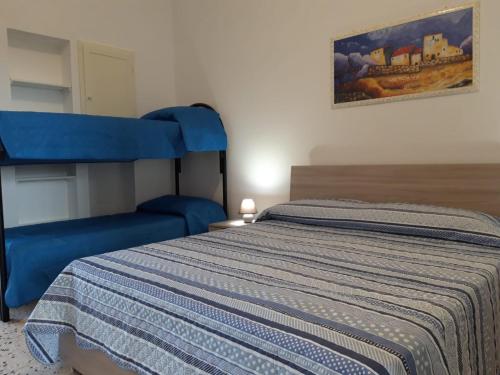 Postel nebo postele na pokoji v ubytování Villetta Li Giannelli