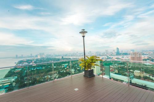 a balcony with a light pole and a city at Infinity 28 Hotel and Residence in Phnom Penh