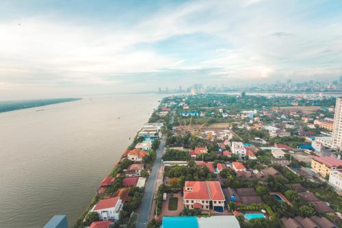 an aerial view of a city next to the water at Infinity 28 Hotel and Residence in Phnom Penh