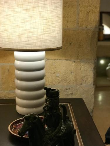 a lamp sitting on top of a table with a horse statue at Ponticelli B&B Boutique in Gravina in Puglia