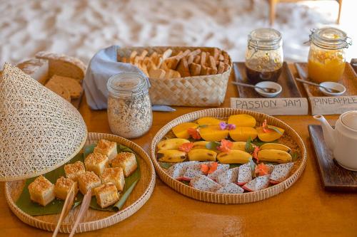 a table with three baskets of food and desserts at Tamu Koh Rong in Koh Rong Island