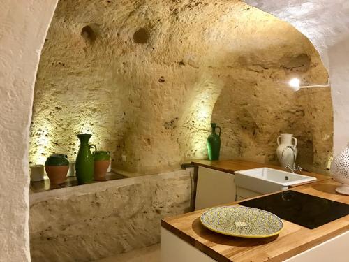 a kitchen with a sink and a counter with vases at Ponticelli B&B Boutique in Gravina in Puglia