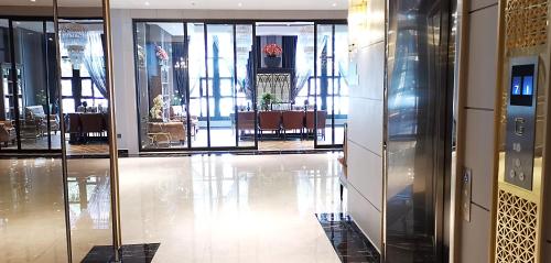 a lobby with glass doors and a dining area at SN Connx - SHA Plus in Pattaya Central