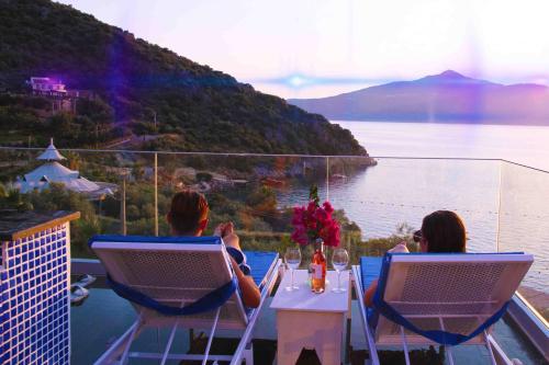 a group of people sitting at a table overlooking a lake at GREENBEACH HOTEL in Kalkan