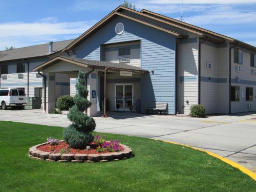a building with a tree in front of it at Travelodge by Wyndham Morrill in Morrill