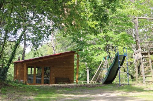 a small building with a slide and a playground at Quinta do Castro Wood House in Marco de Canaveses