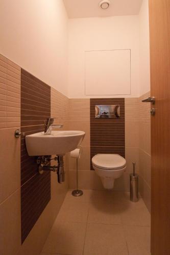 a bathroom with a sink and a toilet at Apollo Apartment - Key-Box - Free Parking in Bratislava