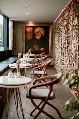 a row of tables and chairs in a restaurant at Hotel President Sarajevo in Sarajevo