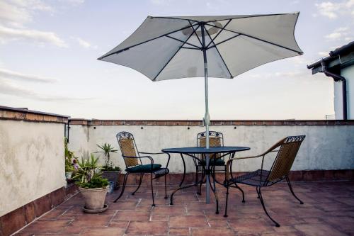 a table and chairs with an umbrella on a patio at Vila Terrasse in Košice