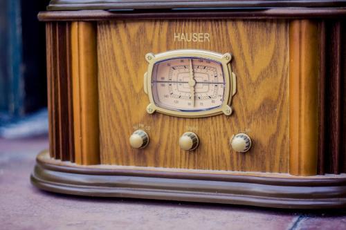 a wooden clock sitting on the side of a building at Vila Terrasse in Košice