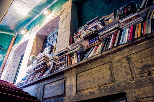 a wooden shelf filled with books on a wall at Vila Terrasse in Košice