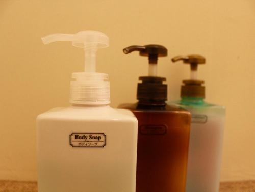 two bottles ofodorizers are sitting next to each other at Guesthouse Hitoyado in Shizuoka