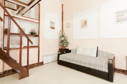 a living room with a bench and a staircase at Rent Apartments Grecheskaya 50 in Odesa