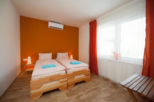 a bedroom with a wooden bed and a window at Ubytování Merlot in Mikulov