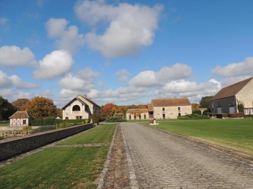 a cobblestone road through a village with buildings at Chambres d'hôtes La Colinière in Batilly-en-Puisaye