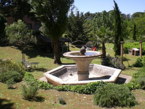 a bird sitting on top of a fountain in a yard at Villa di Christian e Michelle in Rome