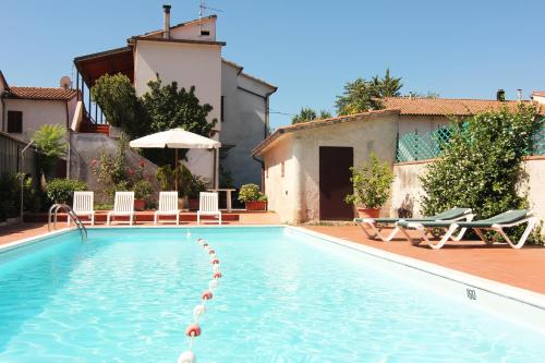 a swimming pool with chairs and a house at Hotel Boni Cerri in Spoleto