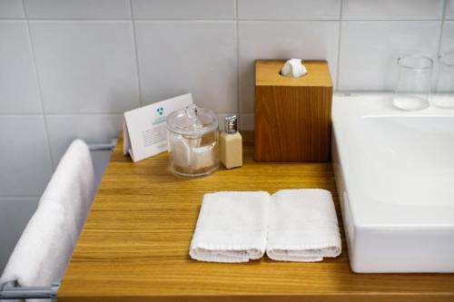 a bathroom with two towels on a counter next to a counter top at Villa Fiorella Art Hotel in Massa Lubrense