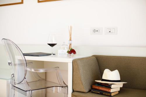 a room with a couch and a table with a hat at Villa Fiorella Art Hotel in Massa Lubrense