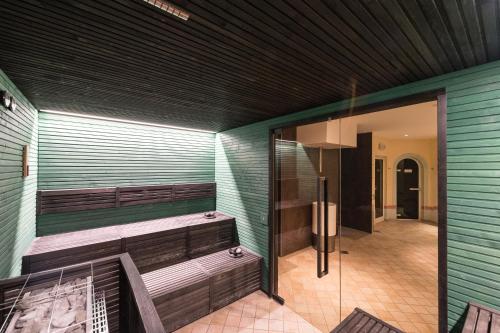 a sauna with wooden benches and a glass door at Grand Hotel Liberty in Riva del Garda