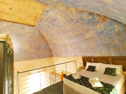 a bedroom with a bed and a ceiling at B&B Corte Kampanes in Gallipoli