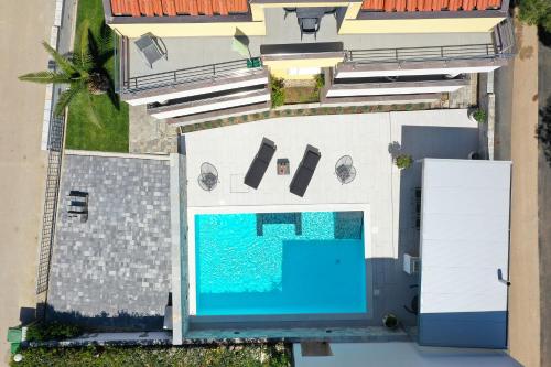 an overhead view of a swimming pool next to a building at Luxury Villa Nada with Pool in Petrcane