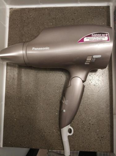 a hair dryer sitting on top of a wall at Just Sleep - Sanchong in Taipei