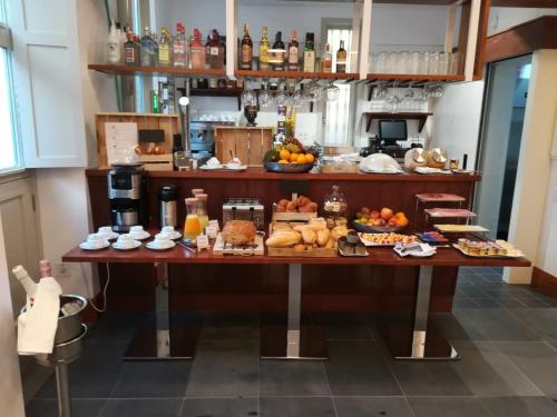 a breakfast table with food and drinks on it at Hotel Emblemático Holiday Time in Santa Cruz de la Palma
