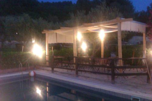 a pavilion with benches and lights at night at Vento Del Sud in Chiaramonte Gulfi