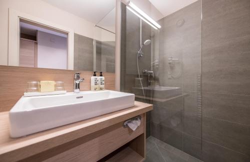 a bathroom with a sink and a shower at Hotel Moserhof in Seeboden